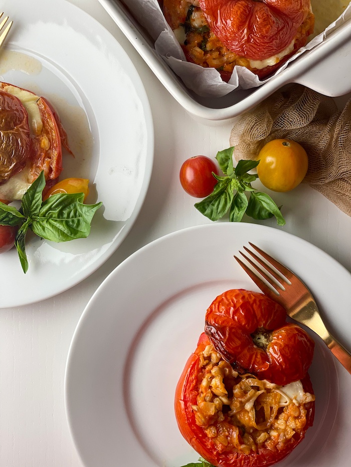 flat lay of farro stuffed tomatoes on plates