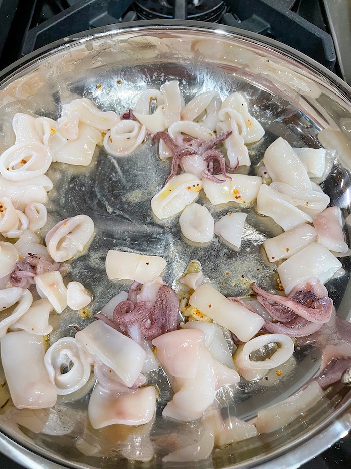 adding calamari to the pot